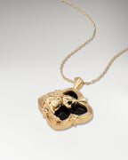 Gold pendant necklace with black agate in a wild encounter design.